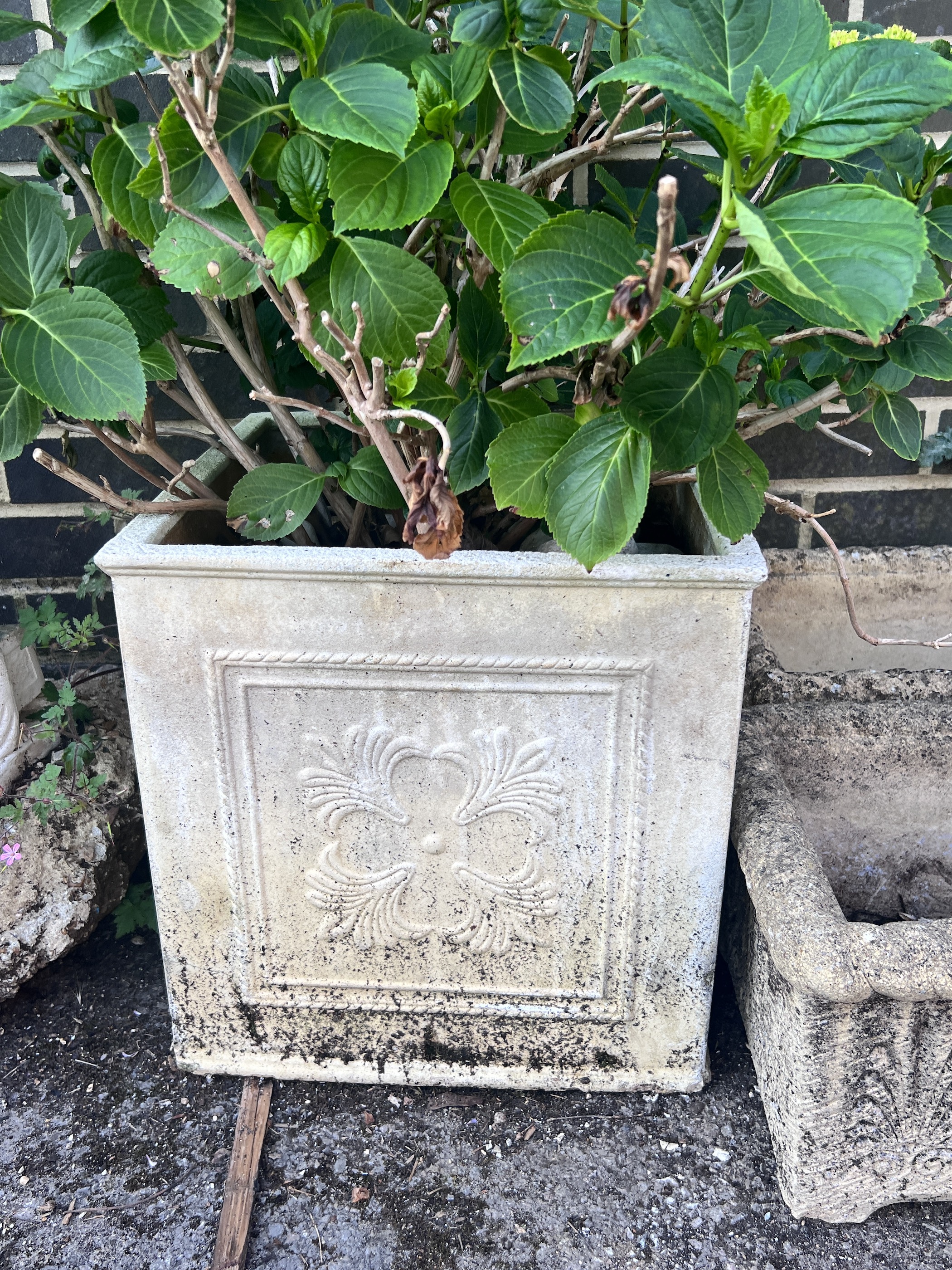 Four reconstituted stone garden planters.
